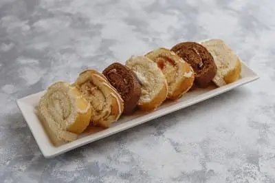 different cake roll slice ceramic plate lihgt with copy space 1